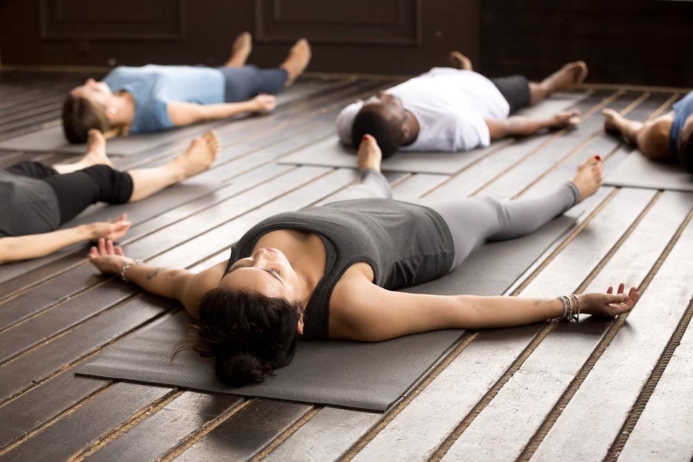 Yoga group in Savasana or Corpse Pose